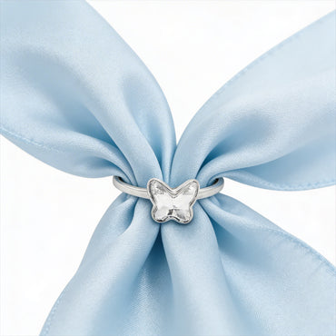 Delicate butterfly ring on fabric