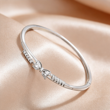 Elegant silver bangle with diamond hearts