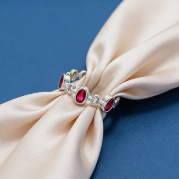 Oval-cut ruby and pink stones for a vibrant contrast