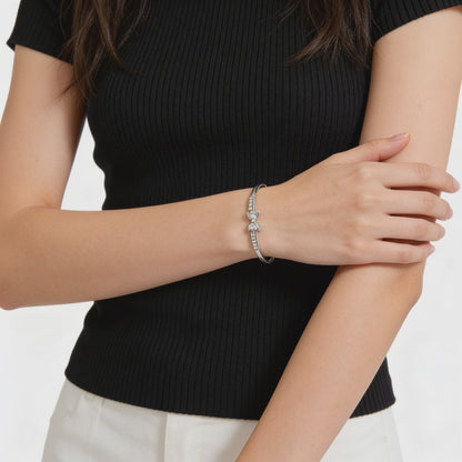 Elegant silver bangle with diamond hearts